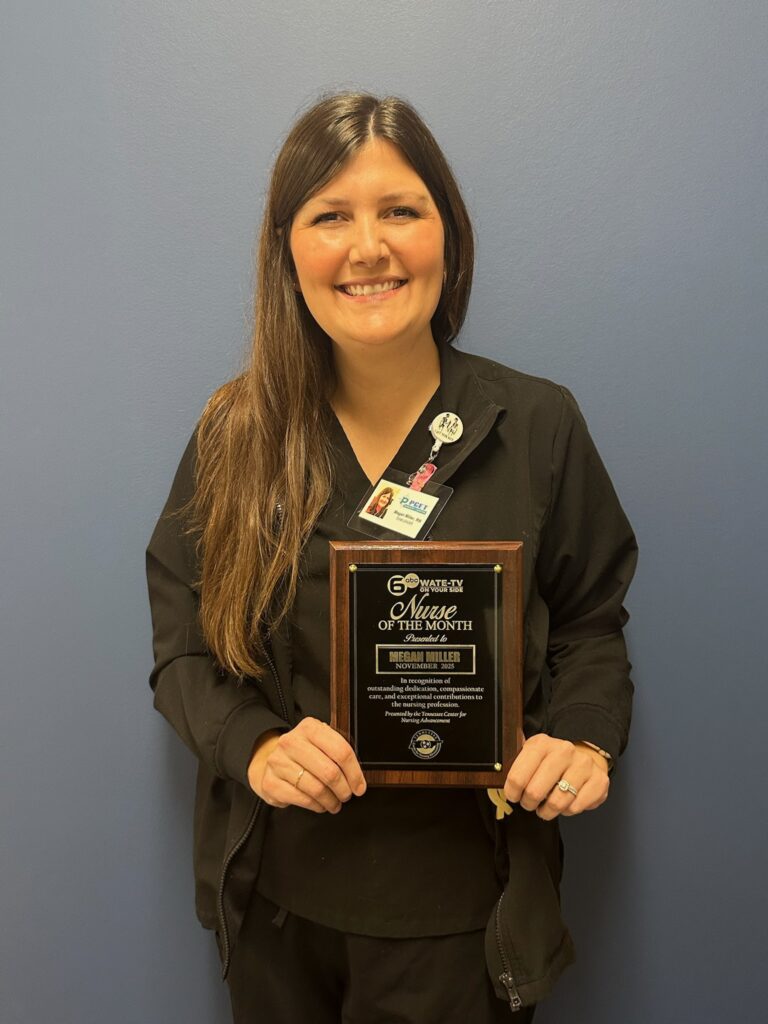 Megan Miller holding a Nurse of the Month plaque from WATE Channel 6 ABC.